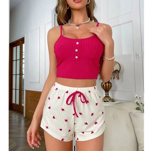Women's two-piece pajama set with pink ribbed camisole and heart print shorts