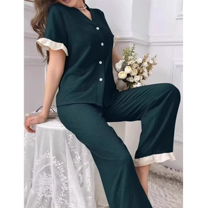 Women's dark green V-neck pajama set with white ruffle trim and matching long pants