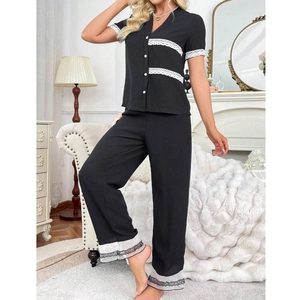 Women's black V-neck short sleeve pajama set with white lace trim and wide leg pants