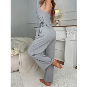Detail of grey spaghetti strap jumpsuit featuring side drawstring and soft knit fabric