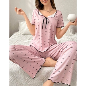 Pink two-piece bow print pajama set with lettuce edge trim and ribbon front tie