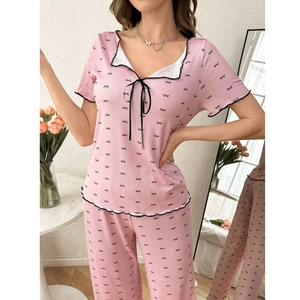 Detail of sweet pink pajama set with bow print, soft ribbed fabric and V-neckline
