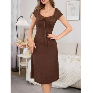 Deep brown lace trim nightdress with bow detail and textured fabric in a cozy home setting