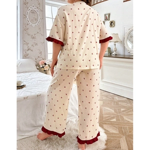 Detail view of plus size pajama set with sweet cherry print and red ruffled trim on back