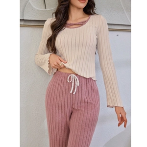 Women's ribbed knit pajama set with cream long sleeve top and purple drawstring pants