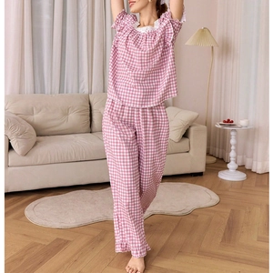 Detail of pink plaid pajama set featuring square lace neckline and soft cotton fabric