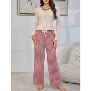 Women's cream knit pajama set with ribbed texture and purple lounge pants detail