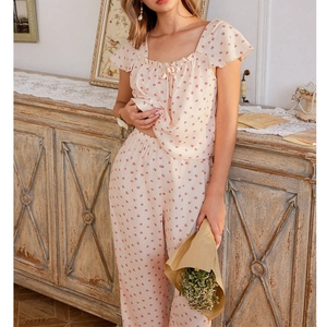 Close-up of floral pajama set with ruffled sleeves and delicate pink flower patterns