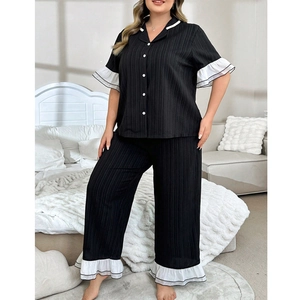 Detail of short sleeve pajama top with white ruffle trim and vertical ribbed fabric