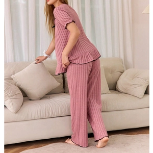 Pink ribbed pajama set with square neck top and long pants featuring lettuce trim details