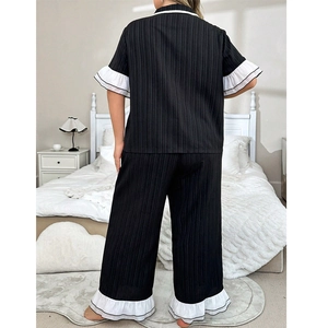 Women's pajama set featuring short sleeve top and pants with white ruffled trim