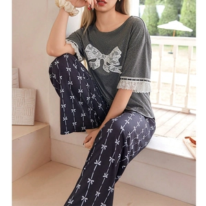 Women's two-piece lace pajama set with short sleeve top and bow print trousers