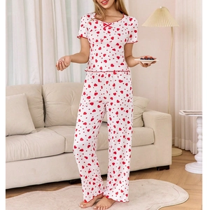 Women's pajama set featuring red heart prints, V-neck short sleeves, and long pants