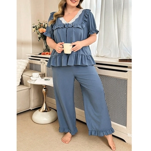 Relaxed women's blue waffle knit pajamas set with V-neck lace trim and ruffle details