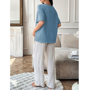 Rear view of loose maternity loungewear set featuring crinkle texture fabric in a home setting