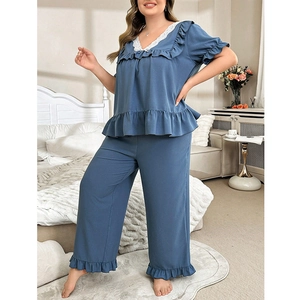 Detail of blue lace V-neck pajama top and ruffled hem on two-piece loungewear set