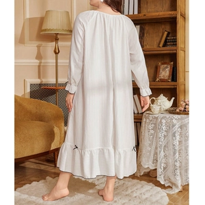 Relaxed white long sleeve nightgown with bow detail and ruffle trim in minimalist style