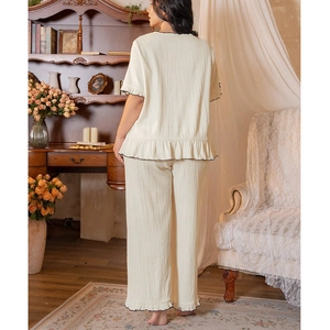 Loose-fit square neck cream loungewear set with black ruffled edges and crepe texture