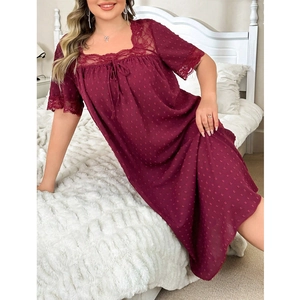 Close-up of burgundy lace square neckline with polka dot texture on nightdress