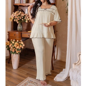 Women's cream two-piece pajama set with ruffle trim and wide-leg trousers in retro style