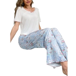 Women's two-piece pajama set with white lace trim top and blue cat print pants