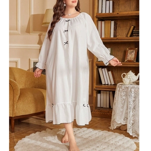 Loose white long-sleeve nightgown with black bows and ruffled hem for women