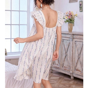 Detail view of floral pajama dress featuring lace flutter sleeves and open back design