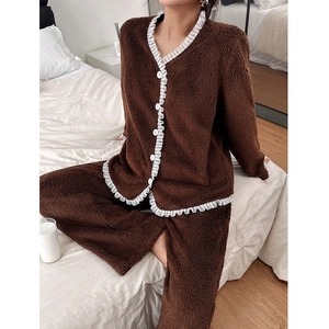 Detail of plush brown fleece pajama set with elegant white lace trim and large buttons