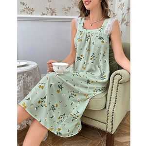Detail of square neckline with white lace trim and light green floral print fabric