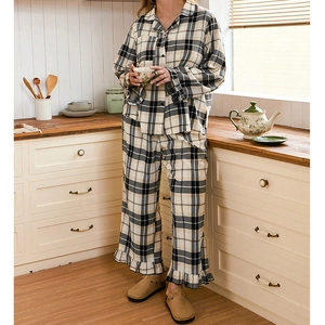 Women's vintage plaid pajama set with ruffle trim and button-down collar in home setting