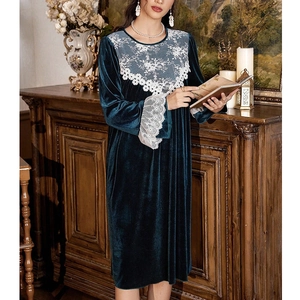 Detail of dark green velvet nightgown showing delicate white lace trim and rich fabric texture