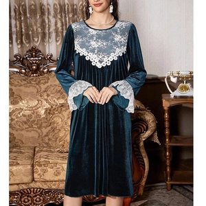 Elegant dark green velvet lounge dress with white lace embroidery in vintage room