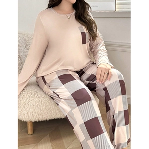 Close-up of soft women's pajamas set featuring round neck top and plaid pattern pants