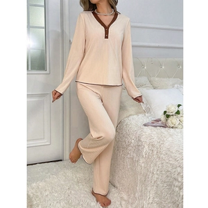 Detail of the V-neck patchwork design and ribbed fabric on a beige women's pajama set