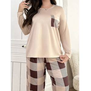 Detail view of round neck pajamas top with checkered pocket and matching long trousers