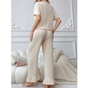Two-piece cream lounge set with pink contrast ruffles and textured seersucker fabric