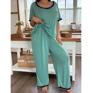 Women's sage green pajama set with short sleeves, lace trim, and wide-leg trousers