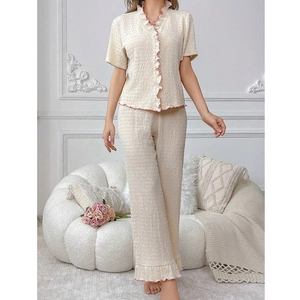 Women's cream pajama set with pink ruffled edges, V-neck short sleeve top and long pants