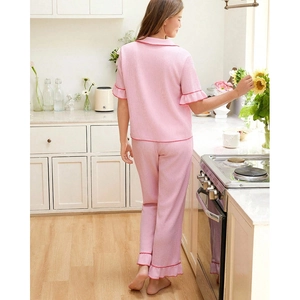 Pink short sleeve pajama set with textured fabric and red ruffled trim for women