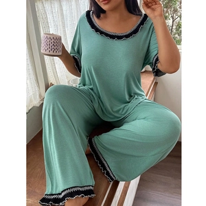 Women's green two-piece pajama set with crew neck short sleeve top and ruffled edge pants