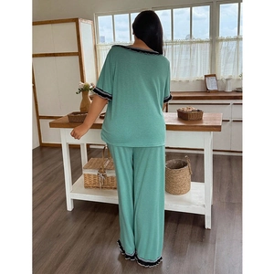 Loose mint green women's pajama set with short sleeves and pants featuring wave lace trim