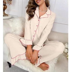 Detail of ruffled cuffs and pink piping on women's ribbed knit pajama set loungewear