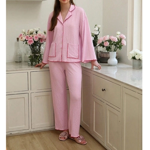 Pink lapel long-sleeve women's pajama set with red contrast piping and waffle texture