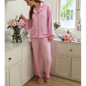 Detail of pink pajama lapel with red piping and textured waffle cotton fabric