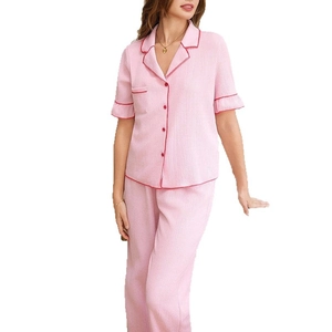 Pink textured pajama set with short-sleeved notched collar top and long pants
