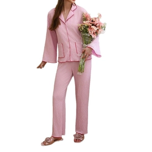 Pink seersucker long sleeve pajama set with red piping and lapel collar for women