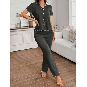 Women's dark gray short sleeve pajama set with white wavy piping and full length pants