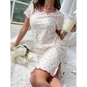 Detail of cherry print sleepwear dress with wavy red hem and side slit design
