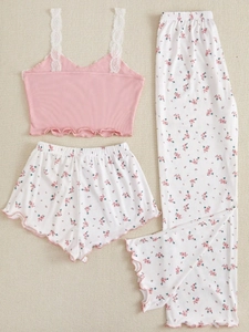 Flat lay of pink floral 3-piece pajama set including camisole, shorts and side slit pants