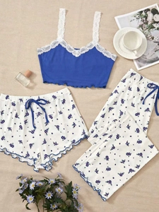 Three-piece floral pajama set with lace camisole, shorts and pants on a cozy background